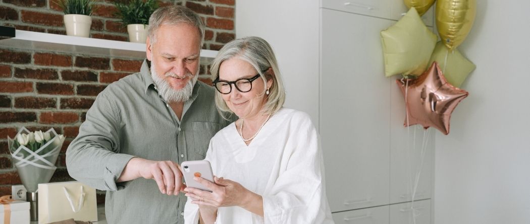 Elderly couple looking at online banking on mobile