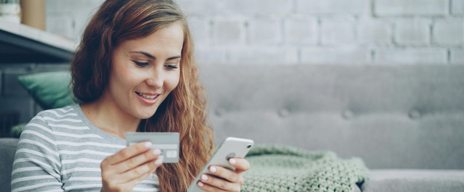 Lady using debit card on her phone
