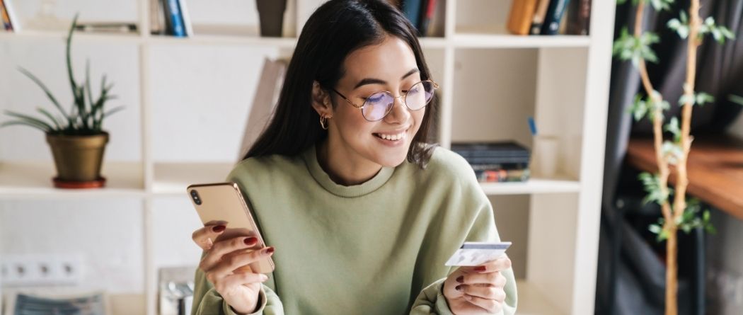 Young lady looking at credit card
