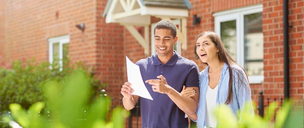 Happy Young Couple looking at home