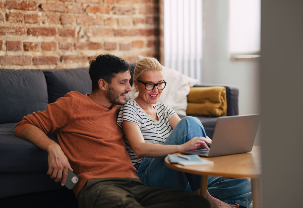 Couple with laptop in living room