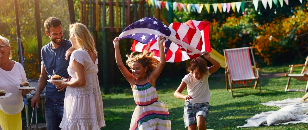 children running with an American flag