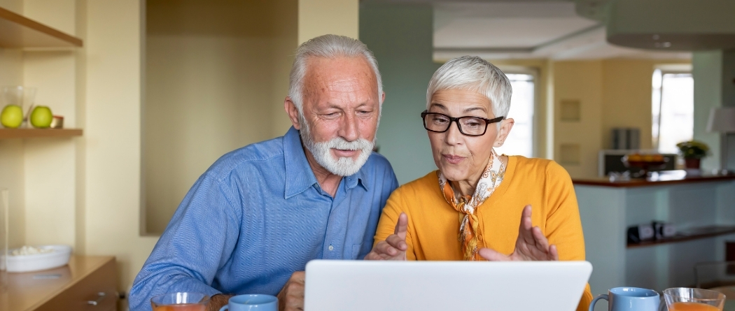 Older couple looking at laptop together