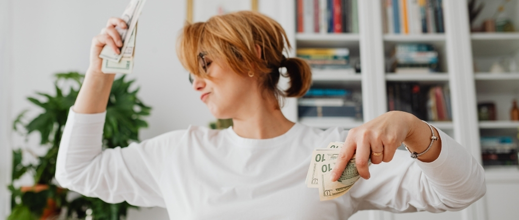 Woman dancing with money in her hands