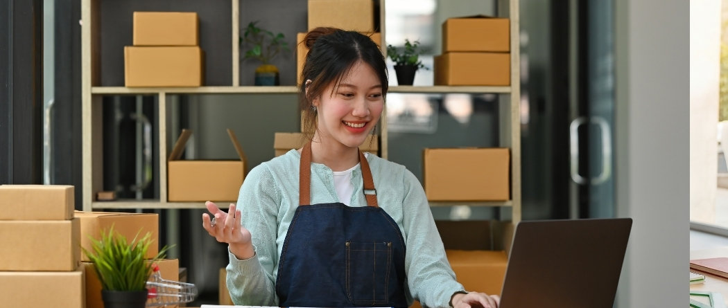 A business owner who is looking at her laptop