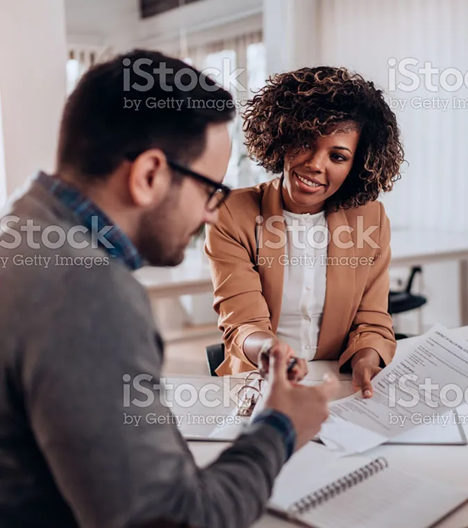 A man and woman filling out paperwork.